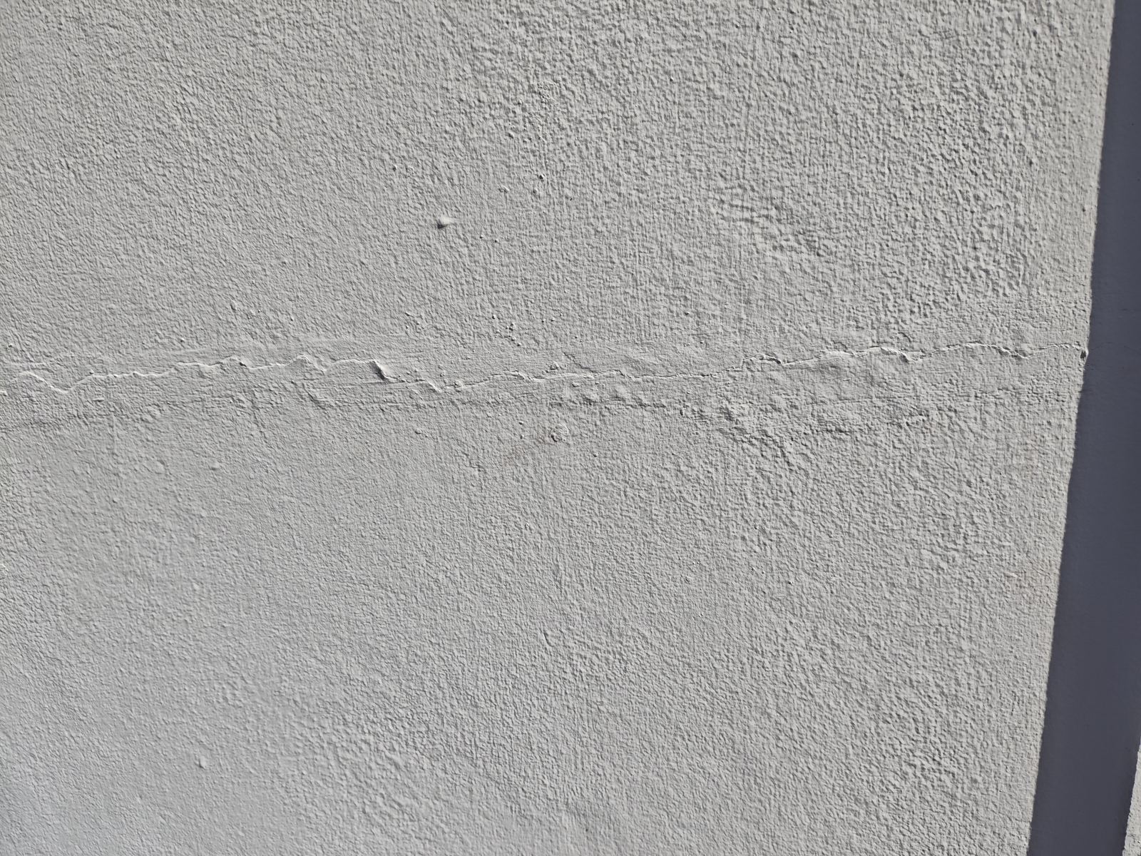 Hairline wall crack photographed during a dilapidation survey