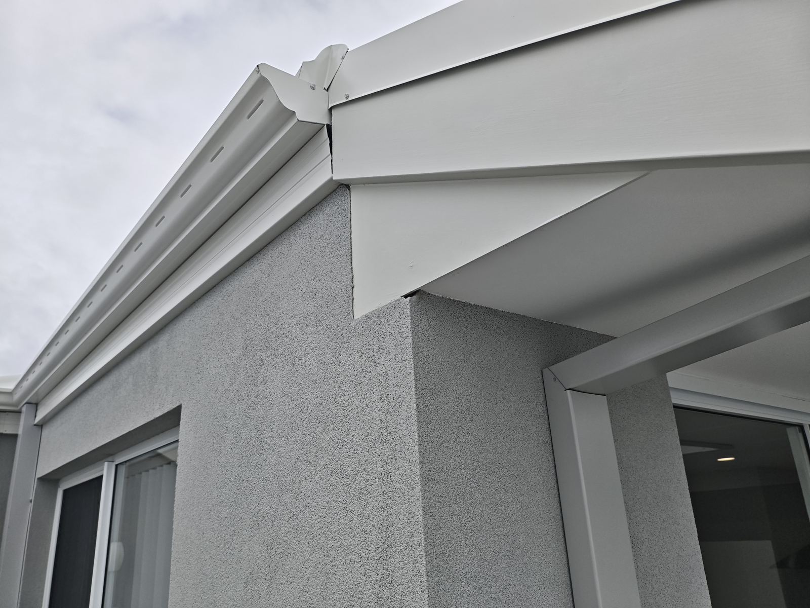 Eave and roofline detail checked during the frame stage of a building progress inspection