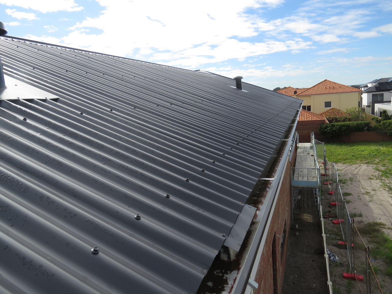 Roof sheeting installation checked during a building progress inspection